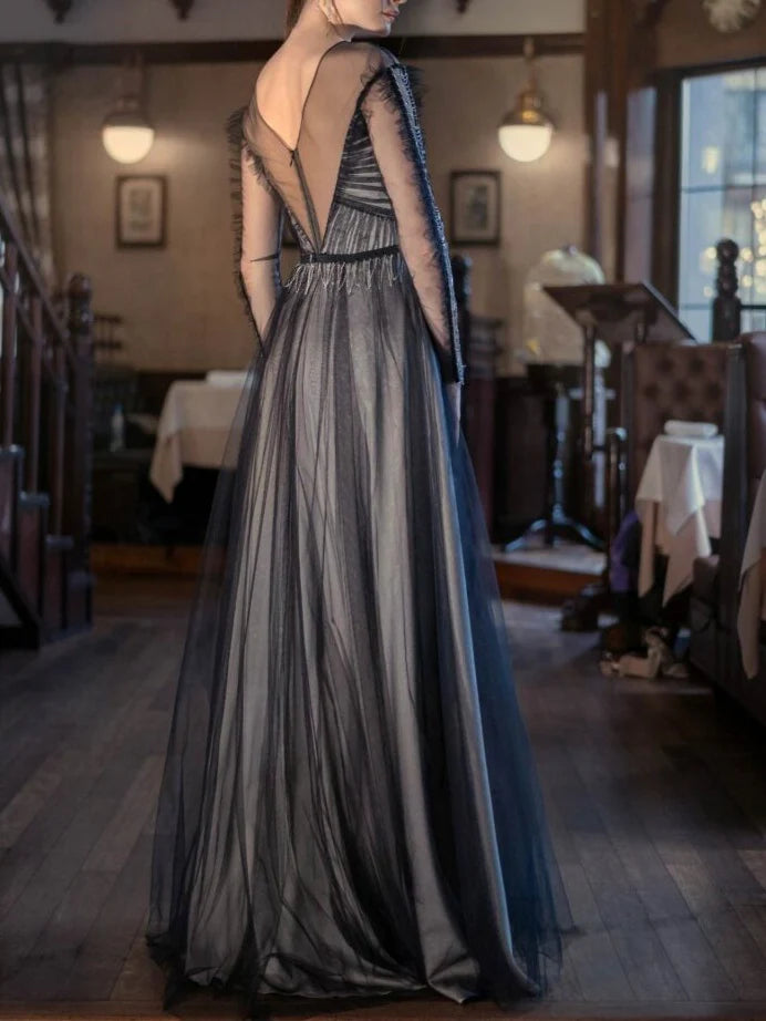 Full view of an A-line scoop neck long sleeve formal gown.