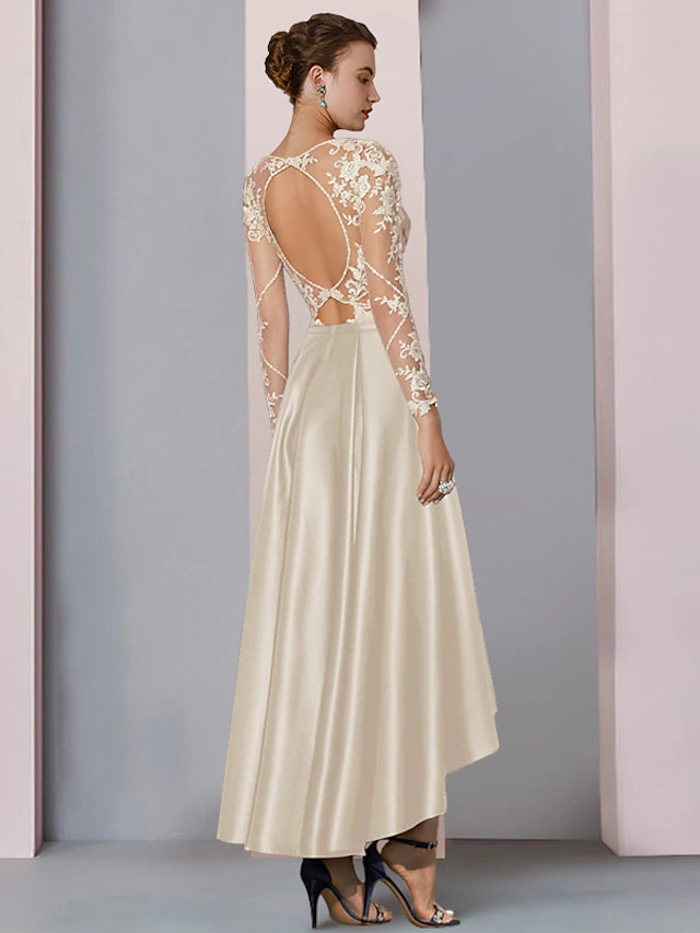 Close-up of satin and lace fabric with beading and appliques on the dress.