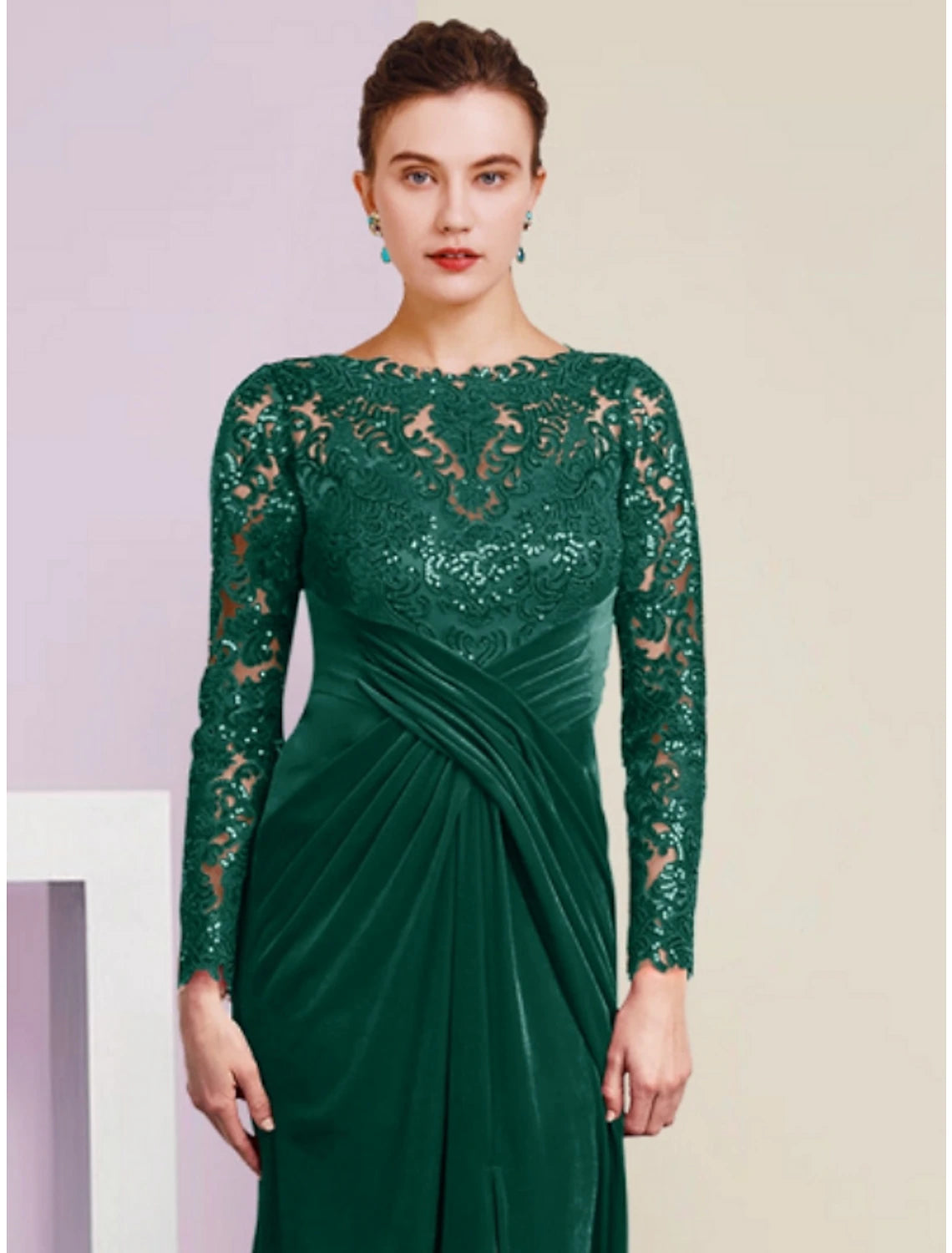 Woman wearing a floor-length velvet gown with lace and sequin details.