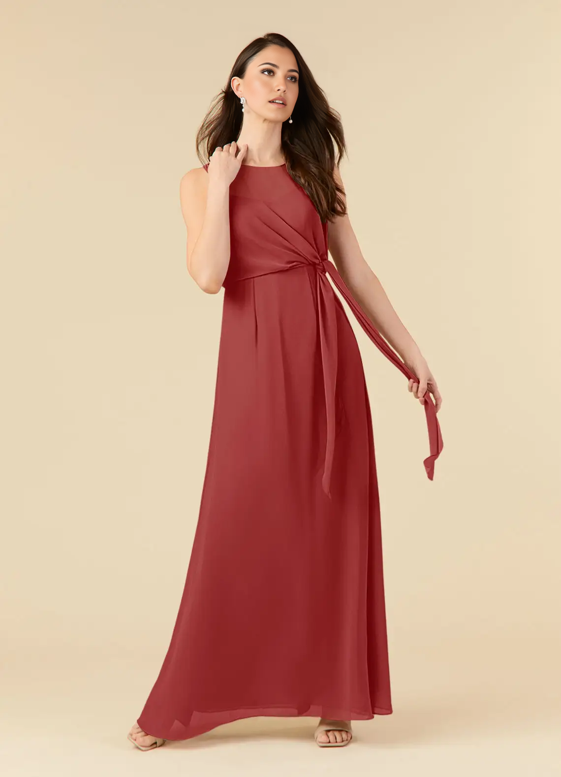 Woman wearing a rust A-line pleated chiffon formal dress.