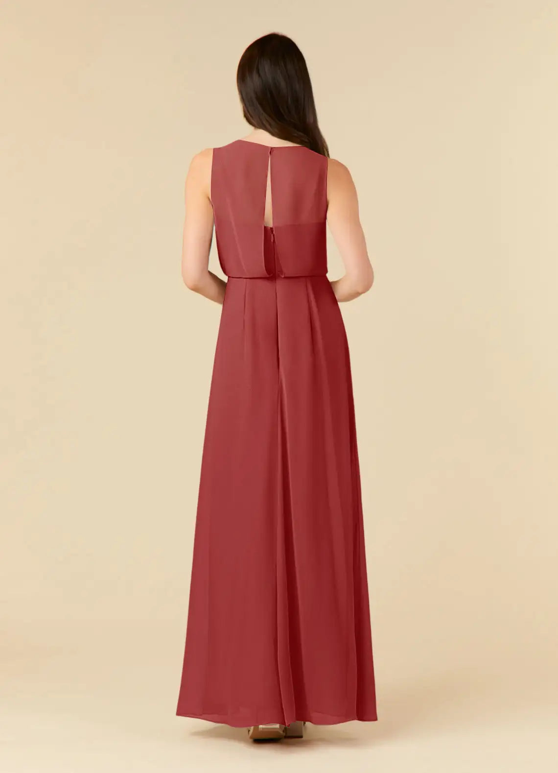 Back view of a woman in a rust A-line pleated chiffon evening gown.