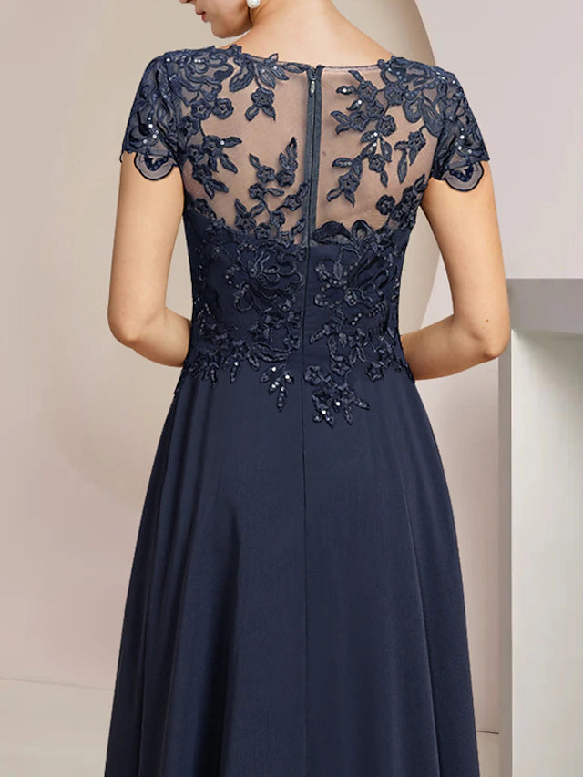 Back view of the high-low tea length formal gown, showcasing the asymmetrical hem and delicate lace details.
