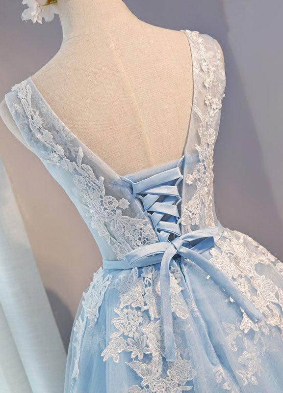 Close-up of intricate lace appliques on a short tulle dress.