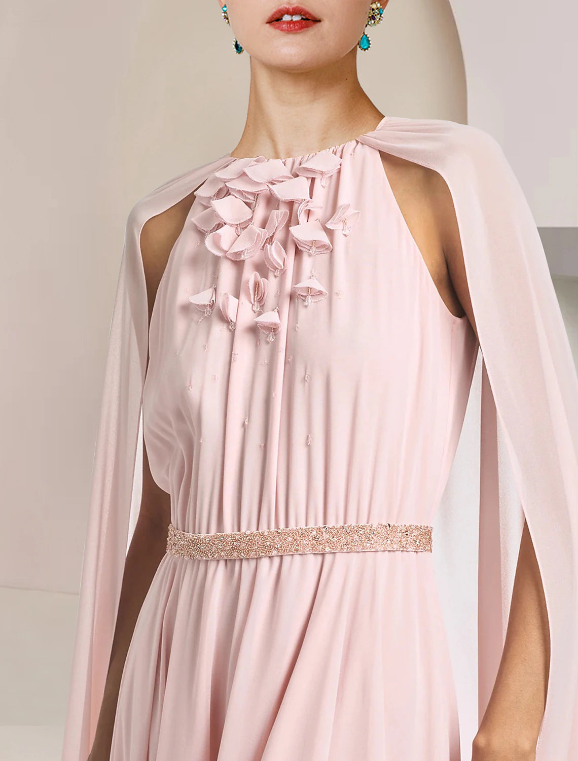 Side view of a flowing sleeveless chiffon gown.
