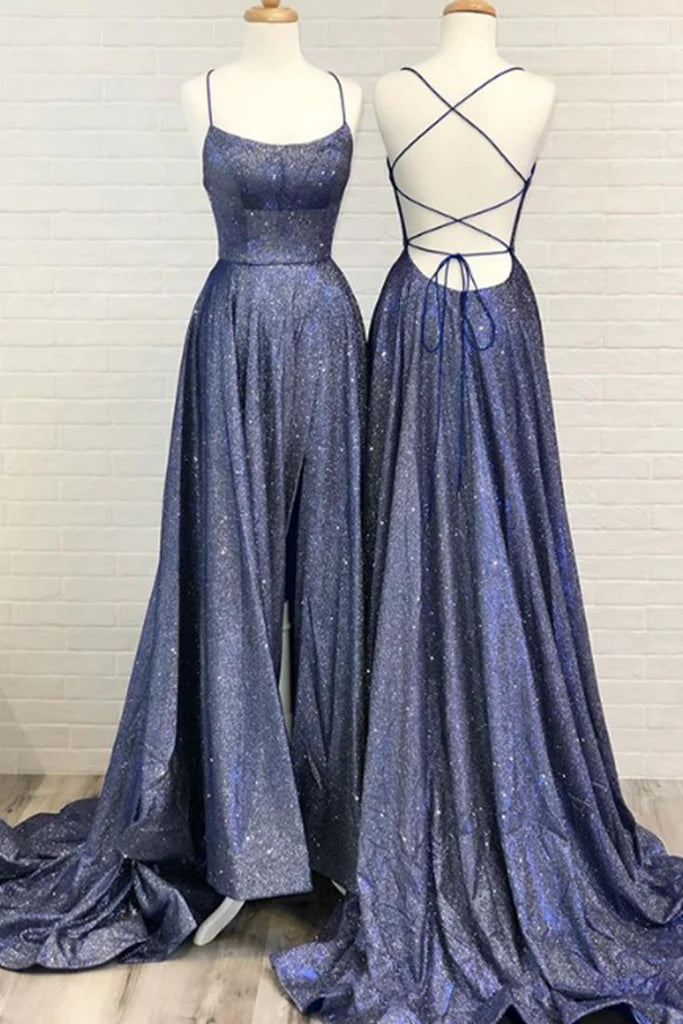 Woman wearing an elegant A-line long prom dress with spaghetti straps and a scoop neck.