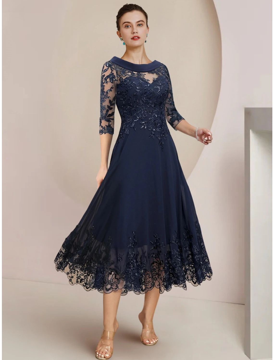 Elegant A-line tea length mother of the bride dress with scoop neck and half sleeves.