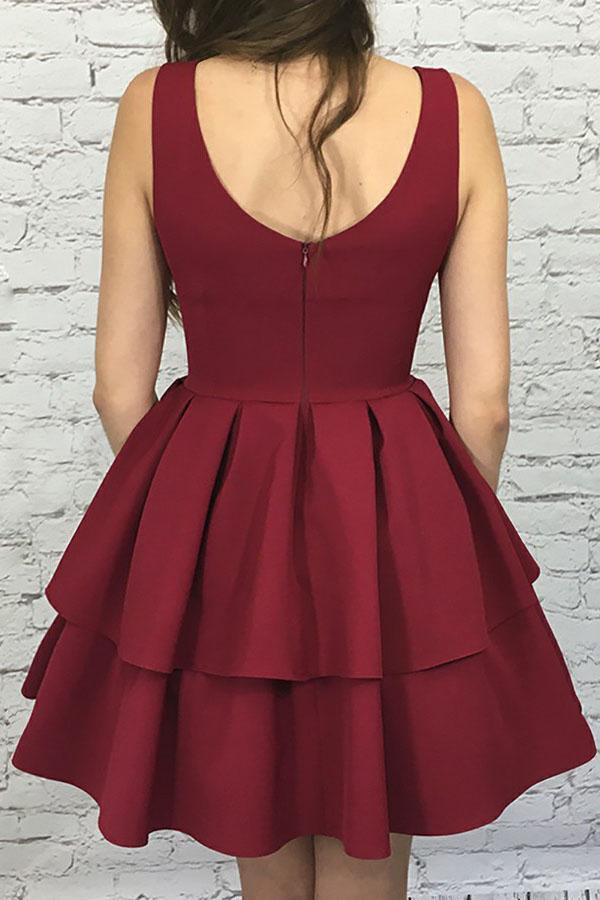 Model wearing a burgundy A-line scoop neck tiered satin short homecoming dress.