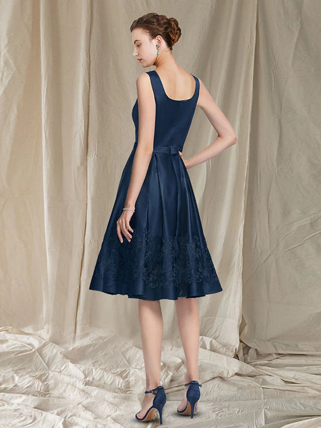 Close-up of the scoop neck and delicate lace appliques on the dress.