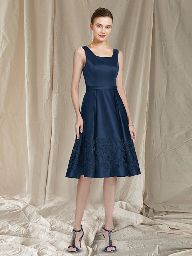 Full view of the Mother of the Bride dress, highlighting the knee-length skirt.