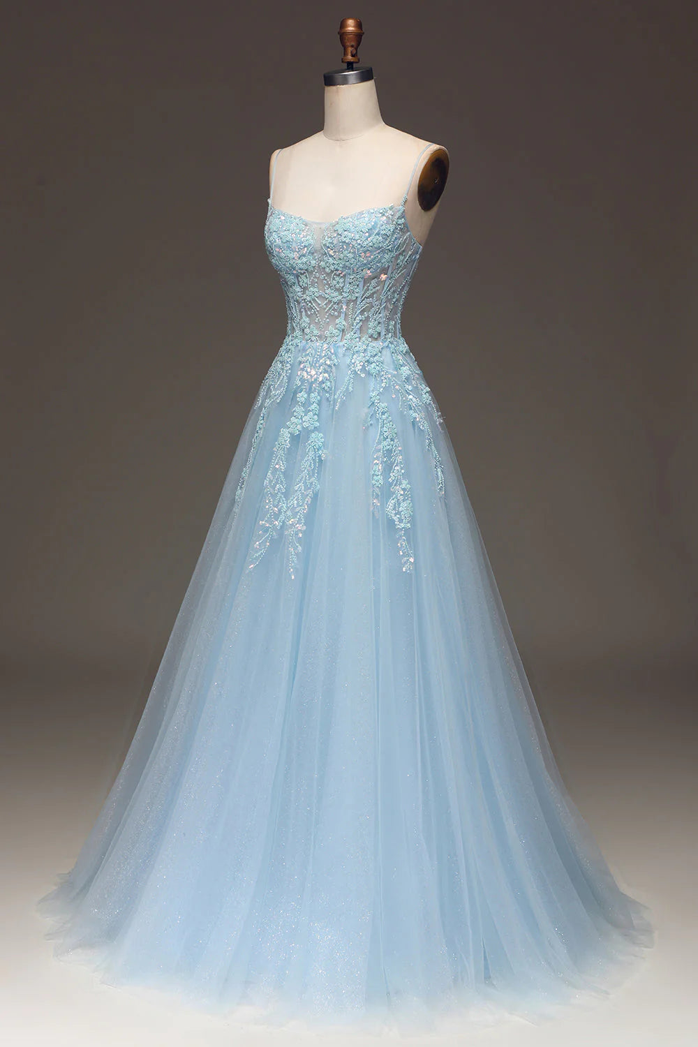 Close-up of the sequin and applique details on a light blue prom dress.