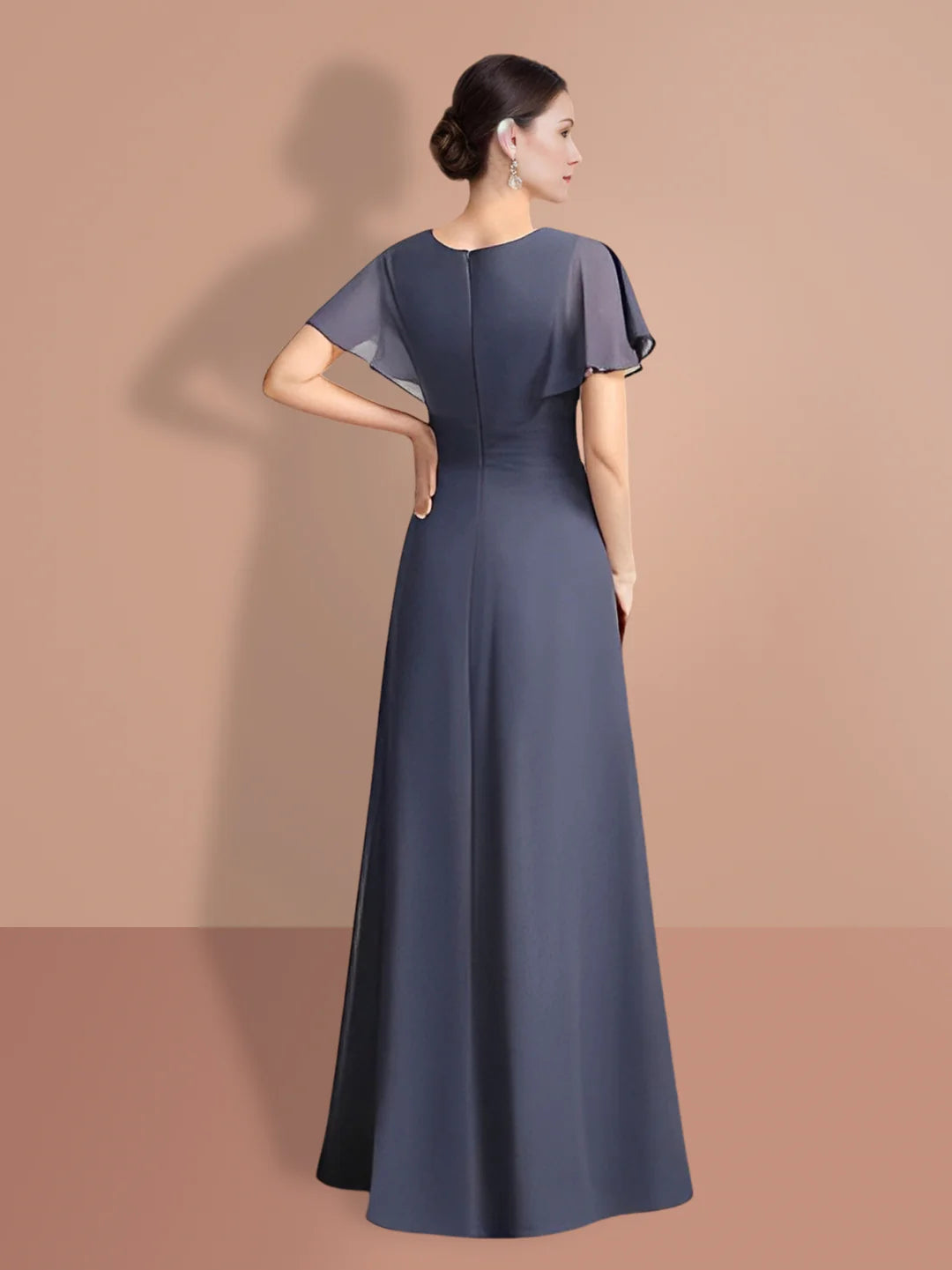 Woman in a dark A-line short sleeve formal dress, side view.