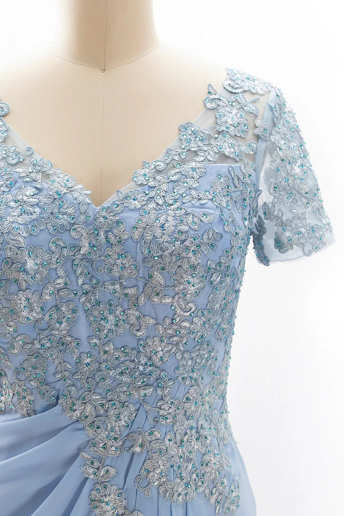 Back view of a woman in an elegant short sleeve lace gown.