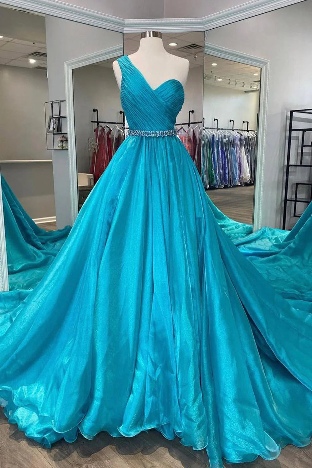 Elegant sky blue A-line prom dress with a beaded waist, front view.