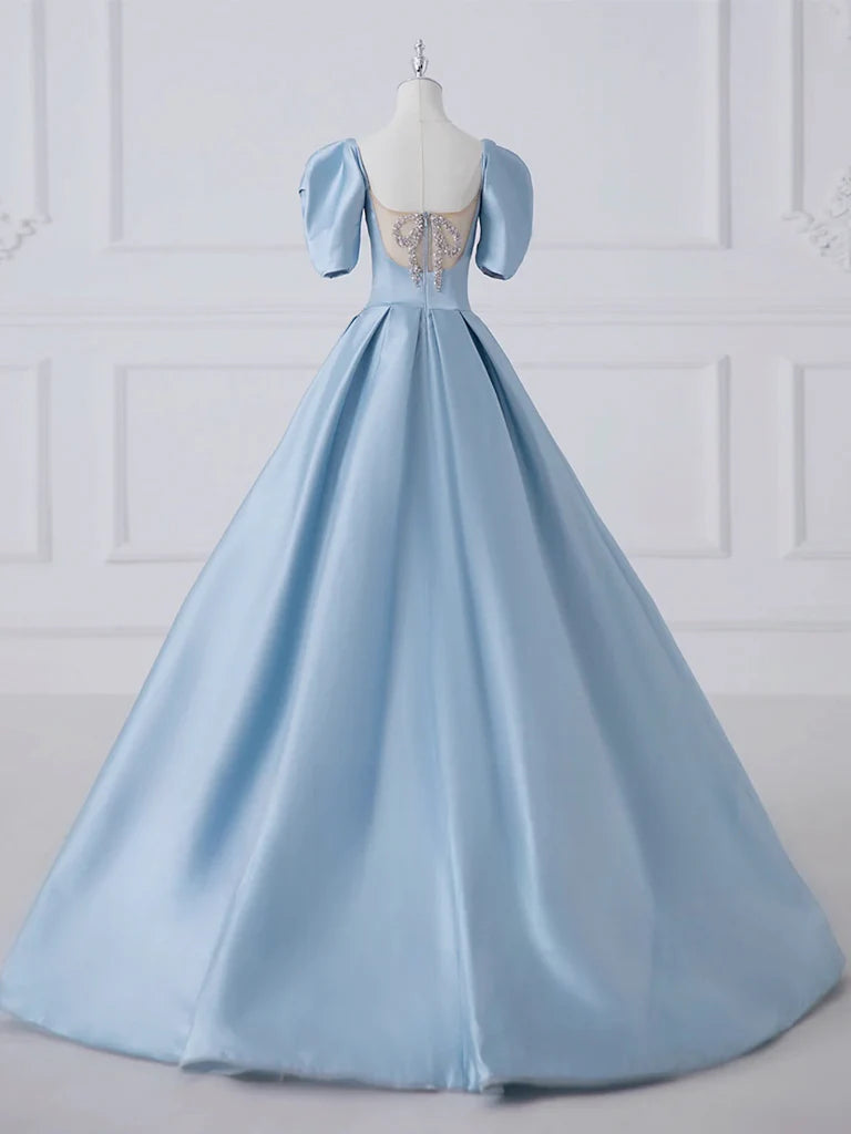 Close-up of the luxurious satin fabric and flowing skirt of the A-line dress.