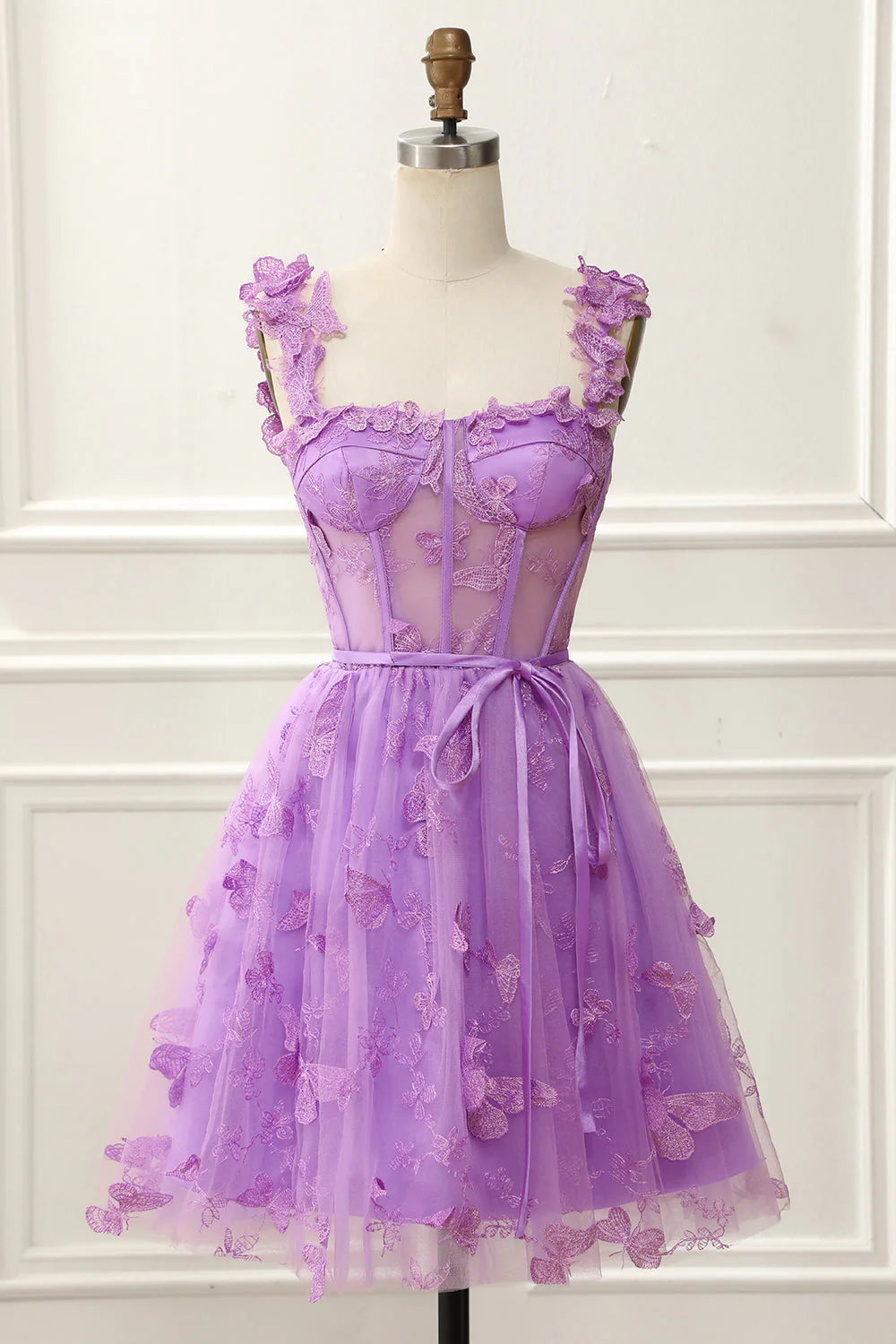 Model wearing a short A-line homecoming dress with 3D butterflies and a side slit.