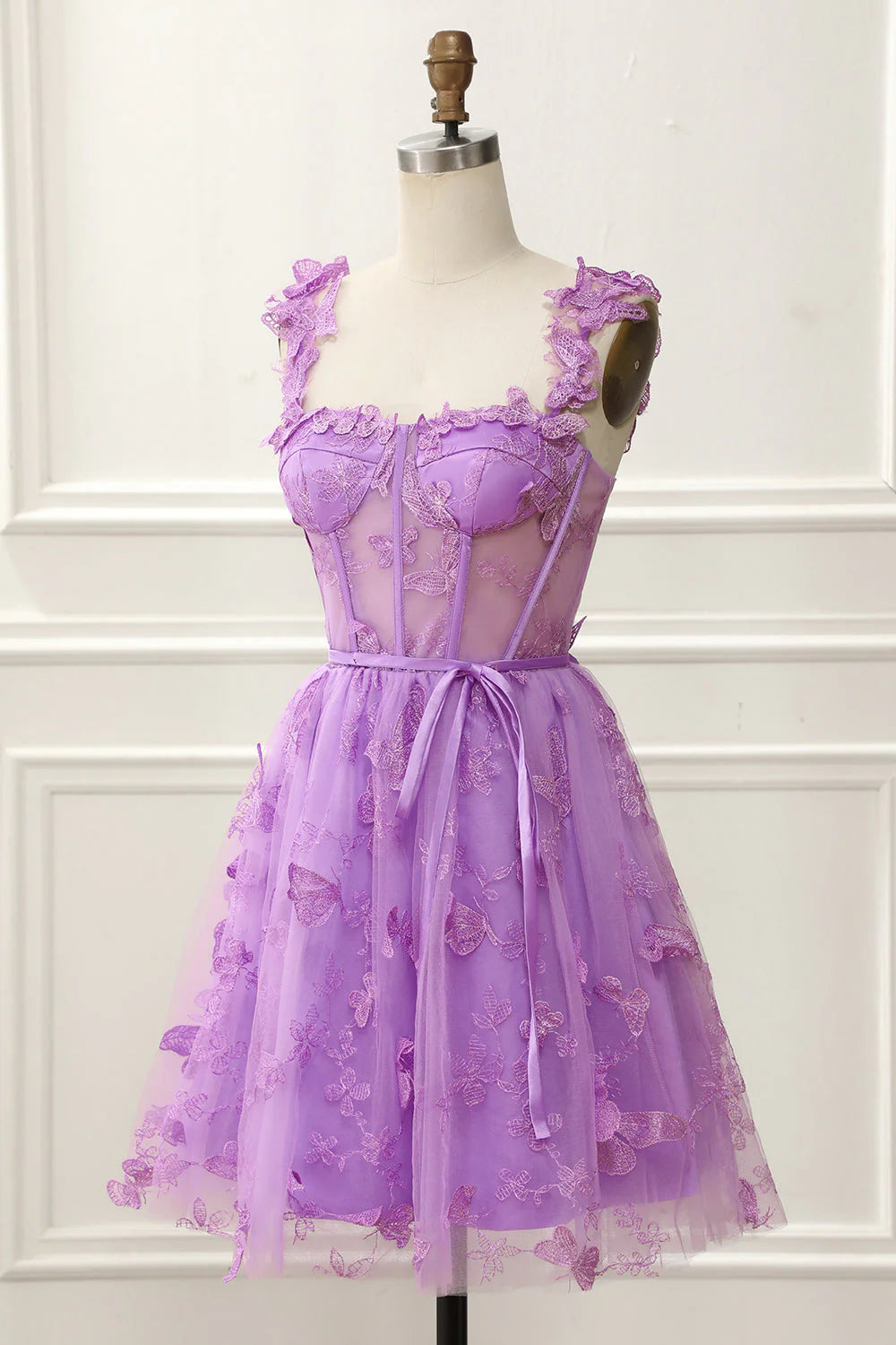 Close-up of the 3D butterfly embellishments on the elegant short formal dress.