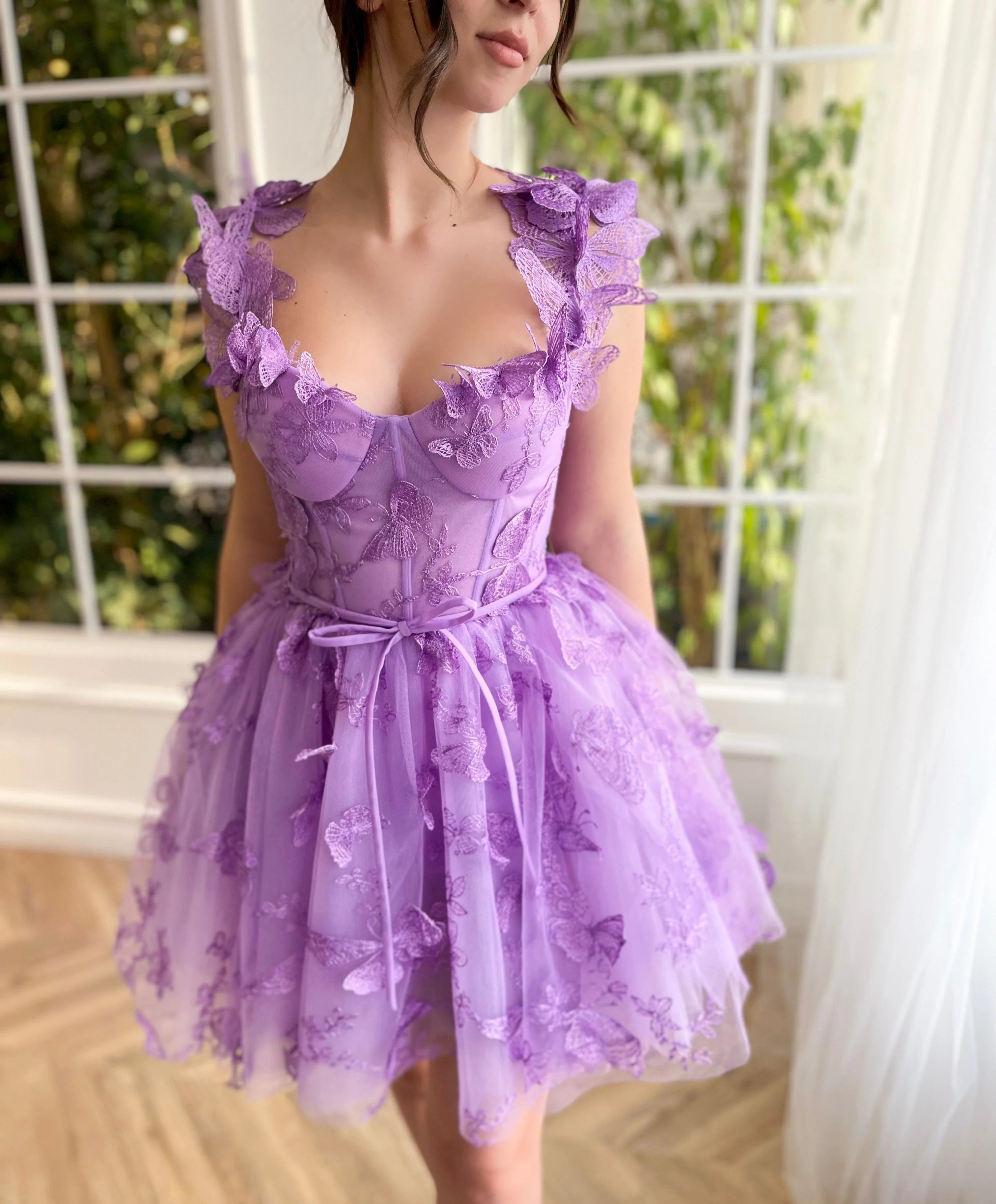 Another angle of the short formal dress, highlighting the delicate fabric and modern design.