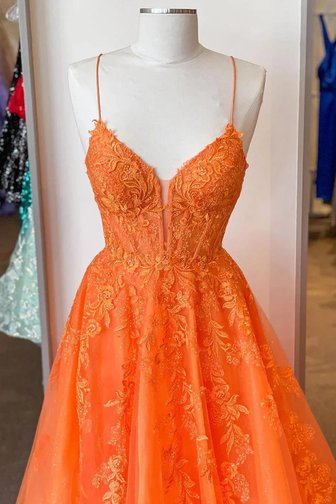 Close-up of the corset bodice and lace appliques on the orange prom dress.