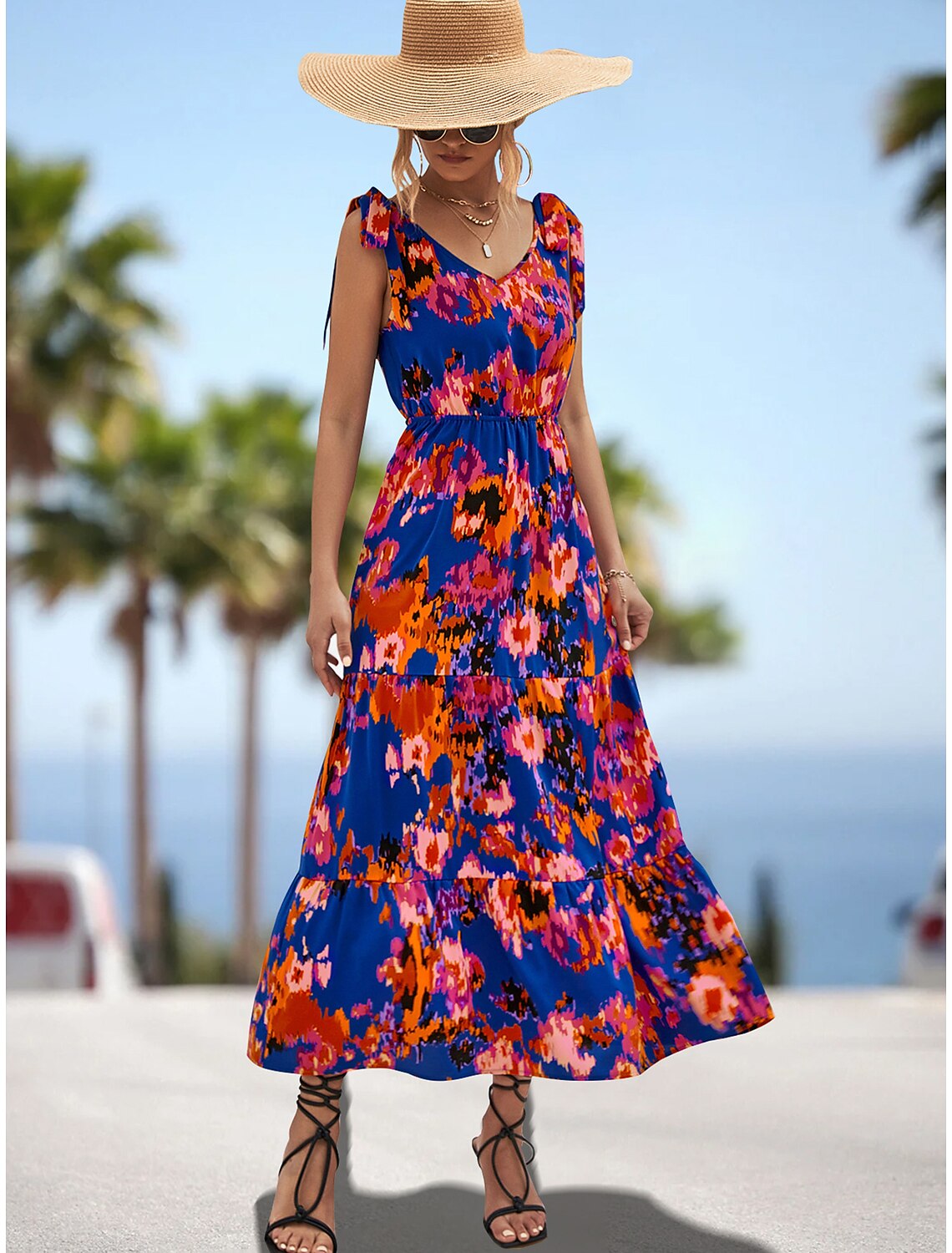 Close-up of the spaghetti strap and neckline detail on the dress.