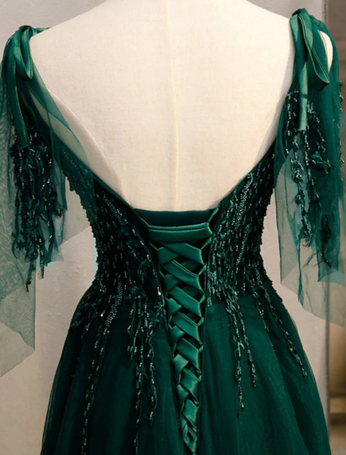 Close-up of the beaded and embroidered details on the formal dress.