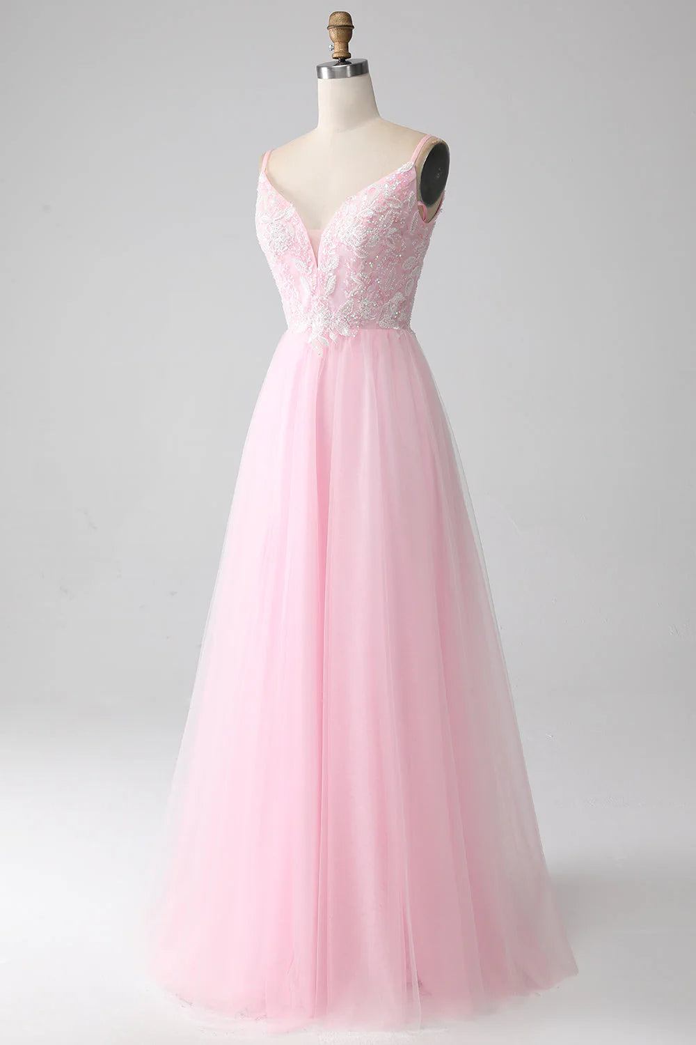 Side profile of elegant light pink spaghetti strap gown.
