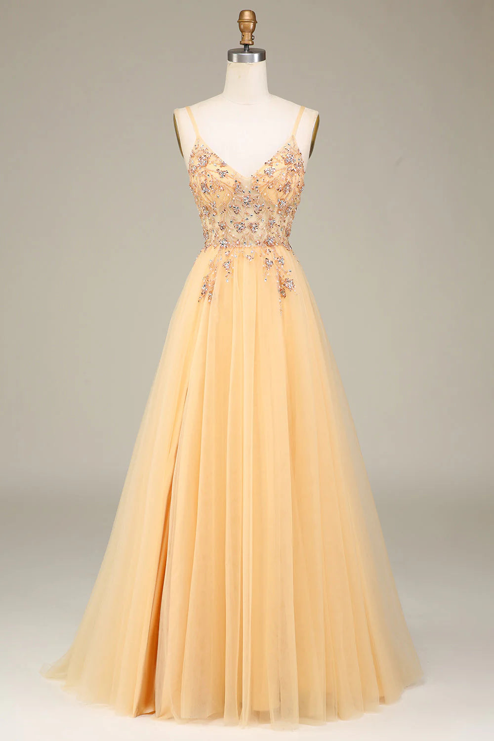 Golden A-line prom dress with spaghetti straps and intricate beading.