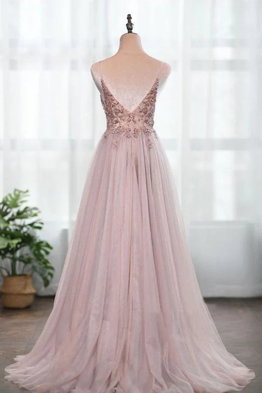 Woman wearing a split tulle A-line formal gown.