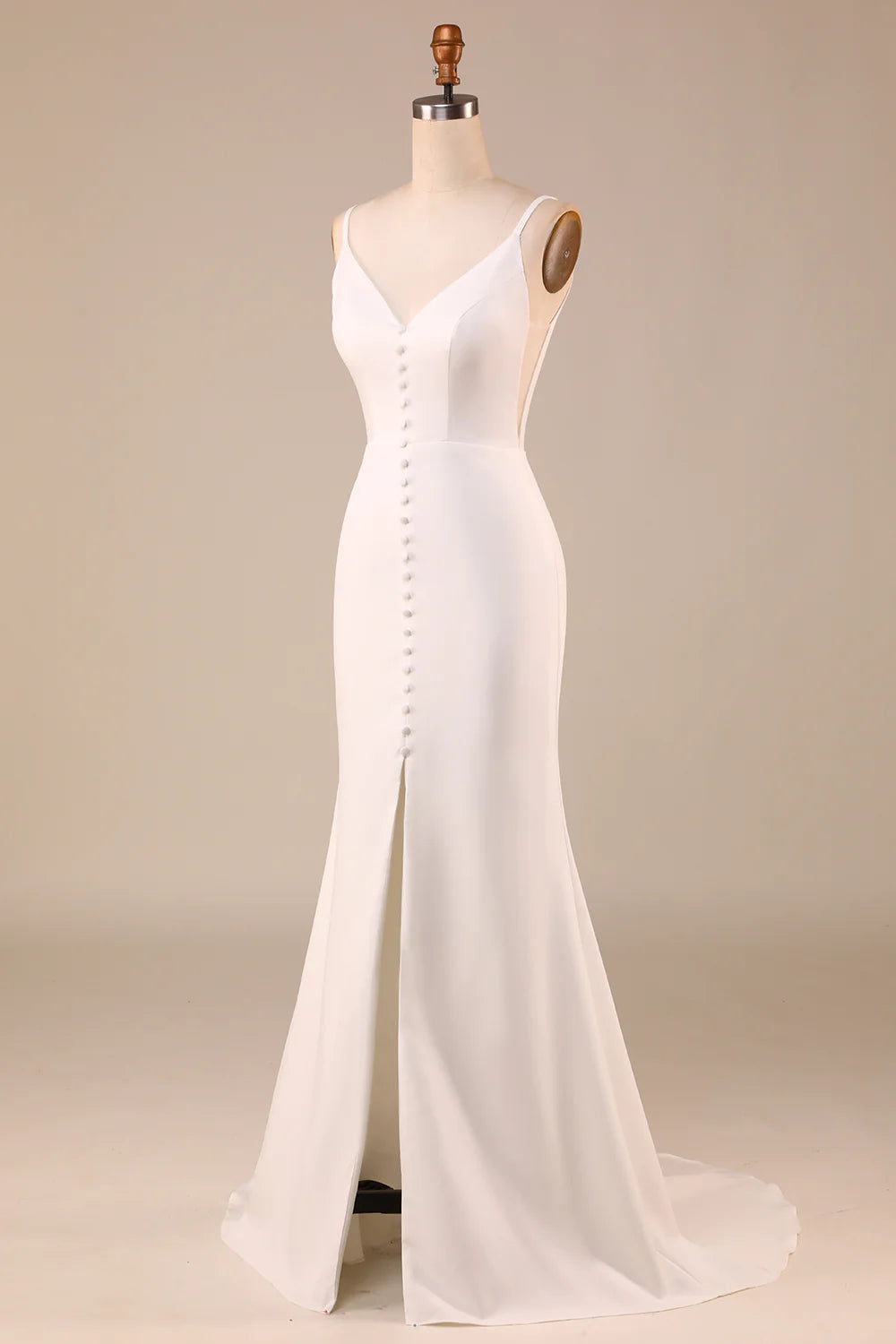 Side profile of ivory A-line wedding dress with spaghetti straps.