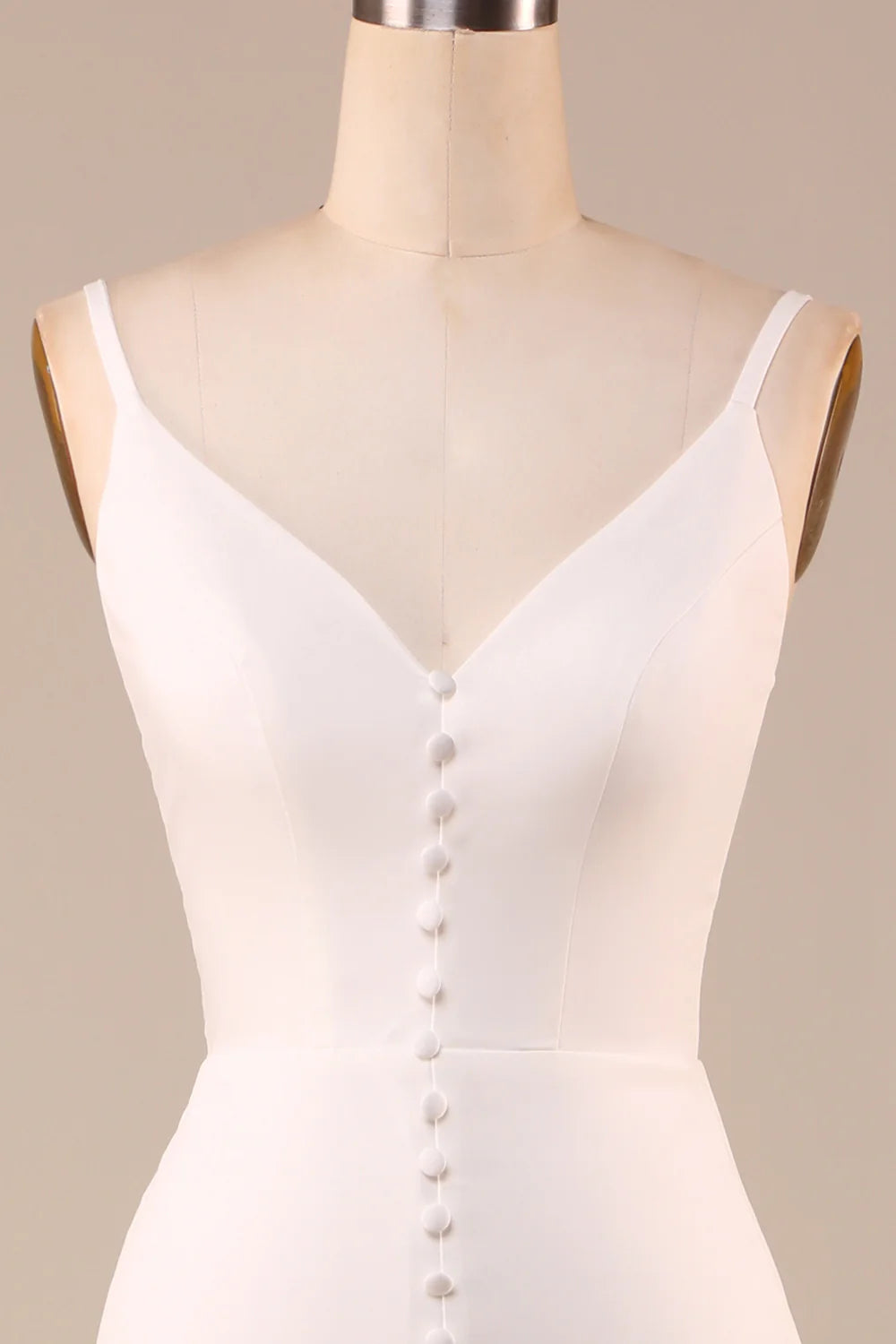 Ivory A-line wedding dress with spaghetti straps, front view.