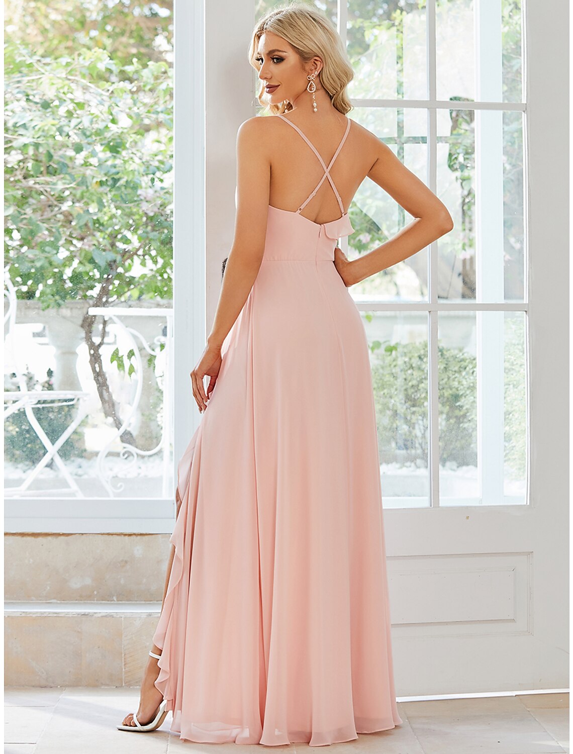 Back view of a woman in a light blue A-line dress, showing the flowing chiffon fabric.