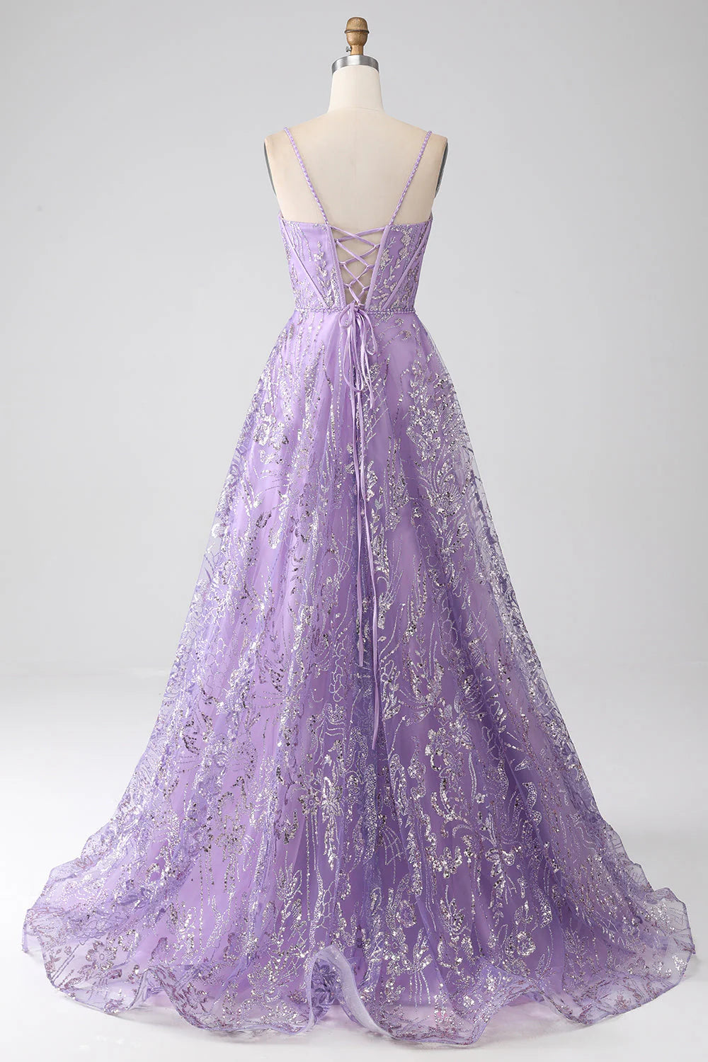 Back view of a lilac A-line prom dress, showing the flowing skirt and corset detailing.