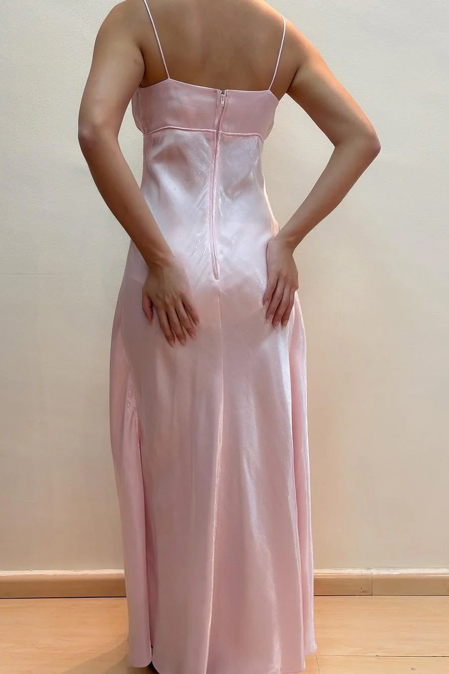 Side view of the long pink empire waist prom dress.