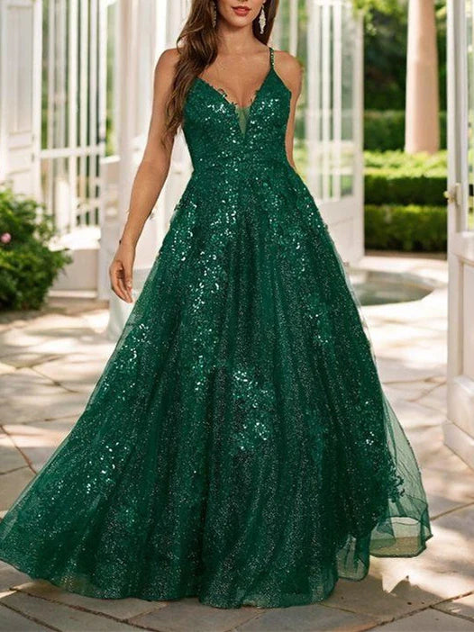 A woman wearing an elegant A-line spaghetti strap floor-length prom dress.