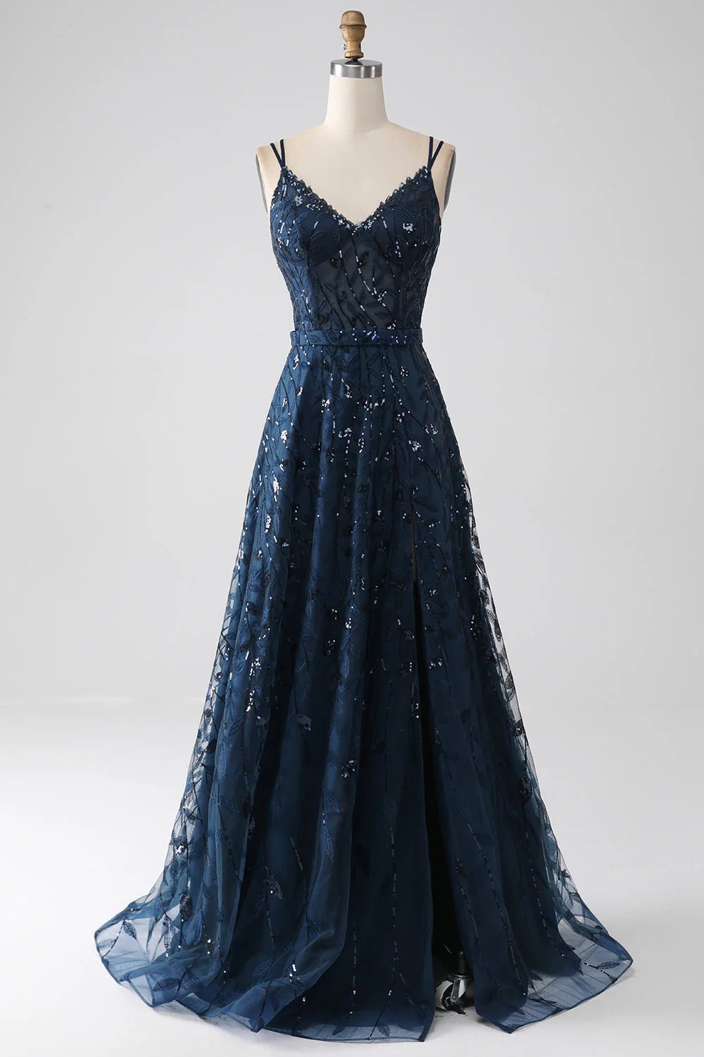 Dark navy A-line prom dress with spaghetti straps and a side slit.