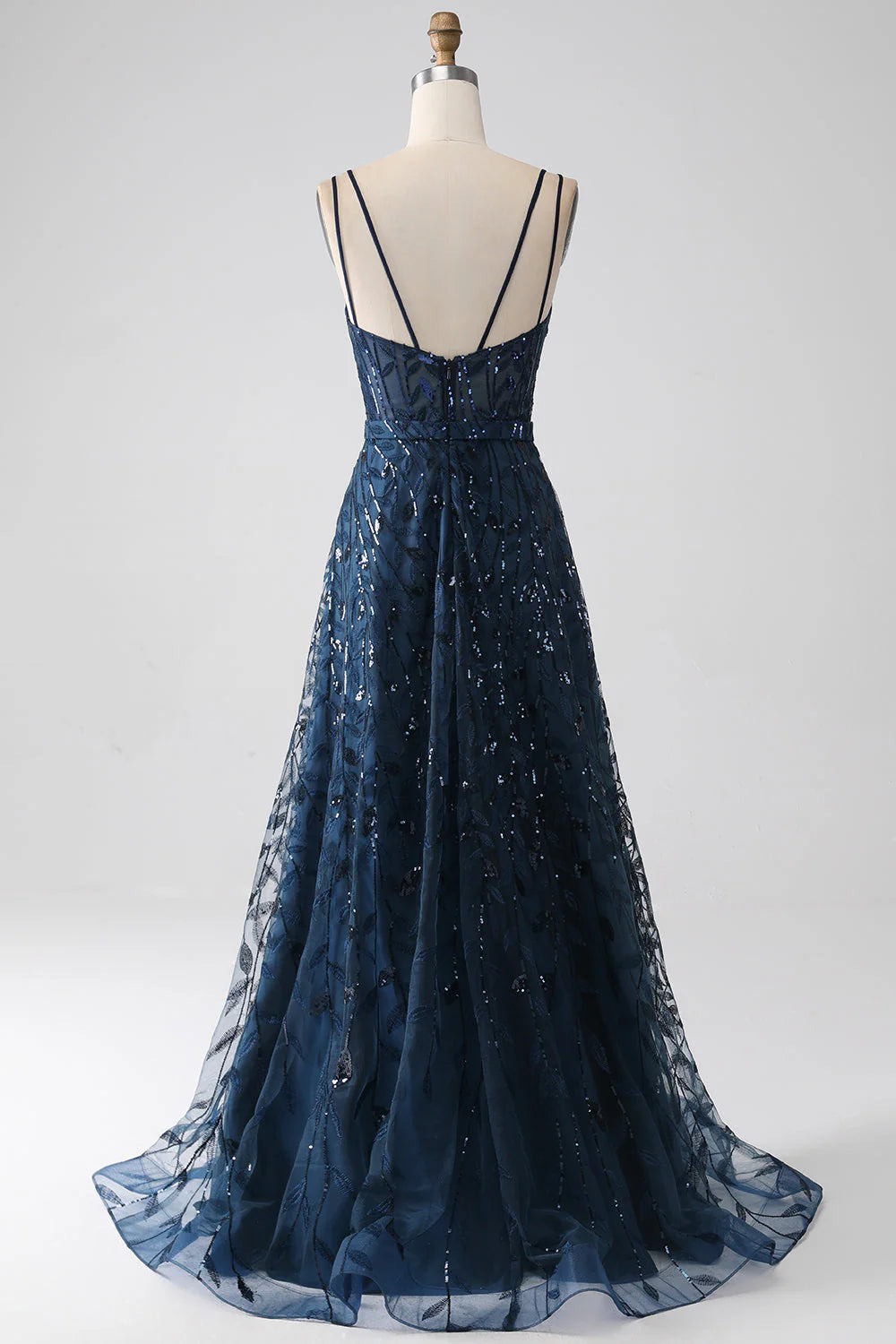 Dark navy A-line prom dress with spaghetti straps and a side slit.
