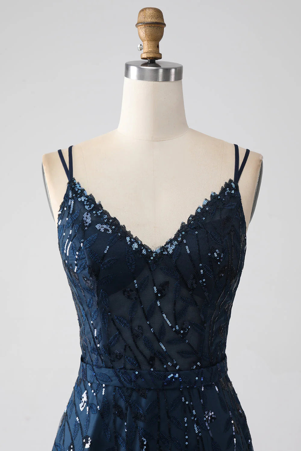 Dark navy A-line prom dress with spaghetti straps and a side slit.