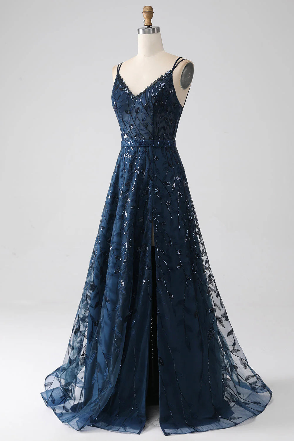Dark navy A-line prom dress with spaghetti straps and a side slit.