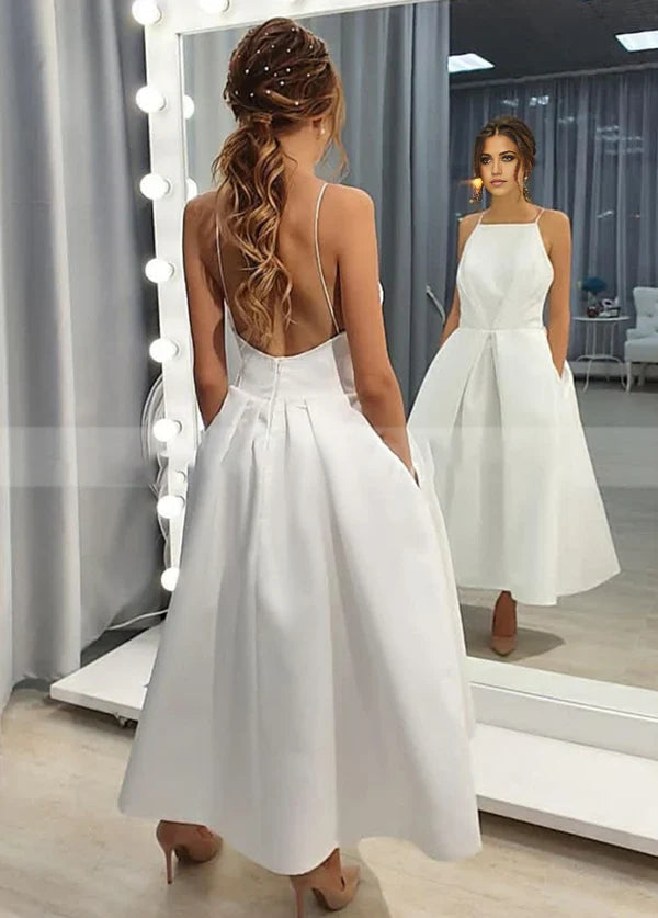 Back view of the tea length wedding dress showcasing the open back design.