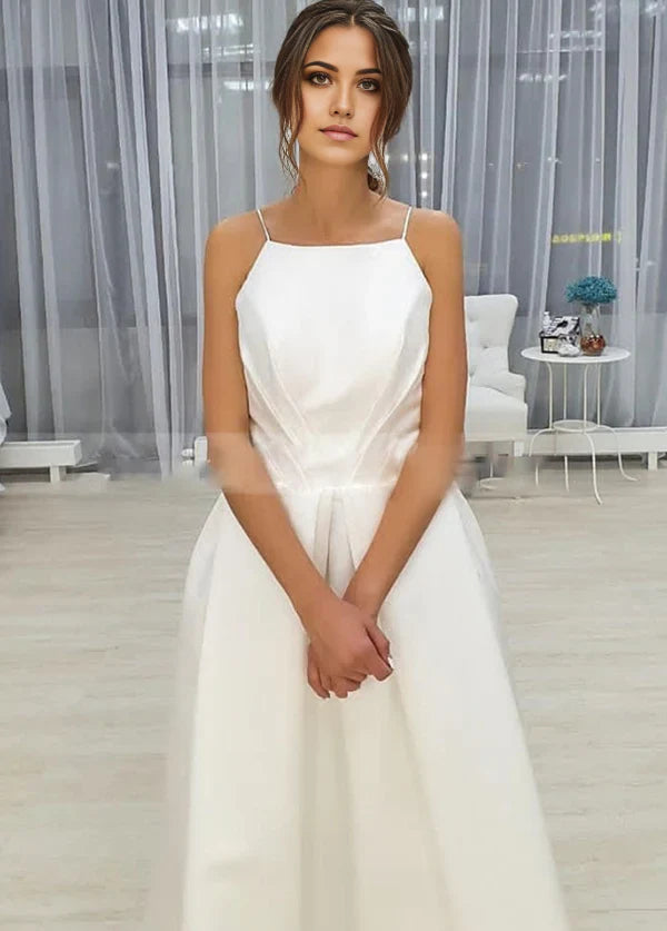 Side view of the A-Line wedding dress, highlighting the tea length skirt and pockets.