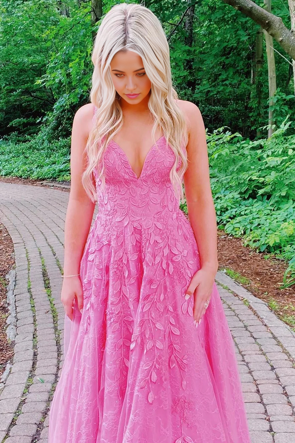 Elegant pink A-line prom dress with spaghetti straps and appliques.