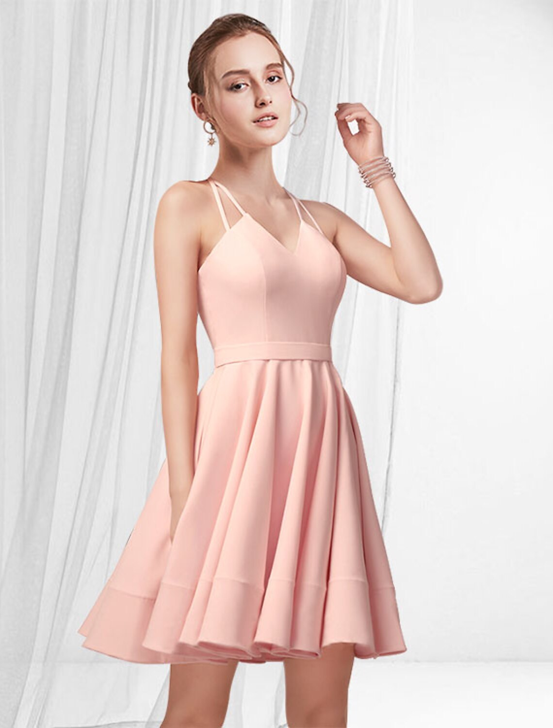 Elegant pink A-line satin mini dress with spaghetti straps and pleated skirt.