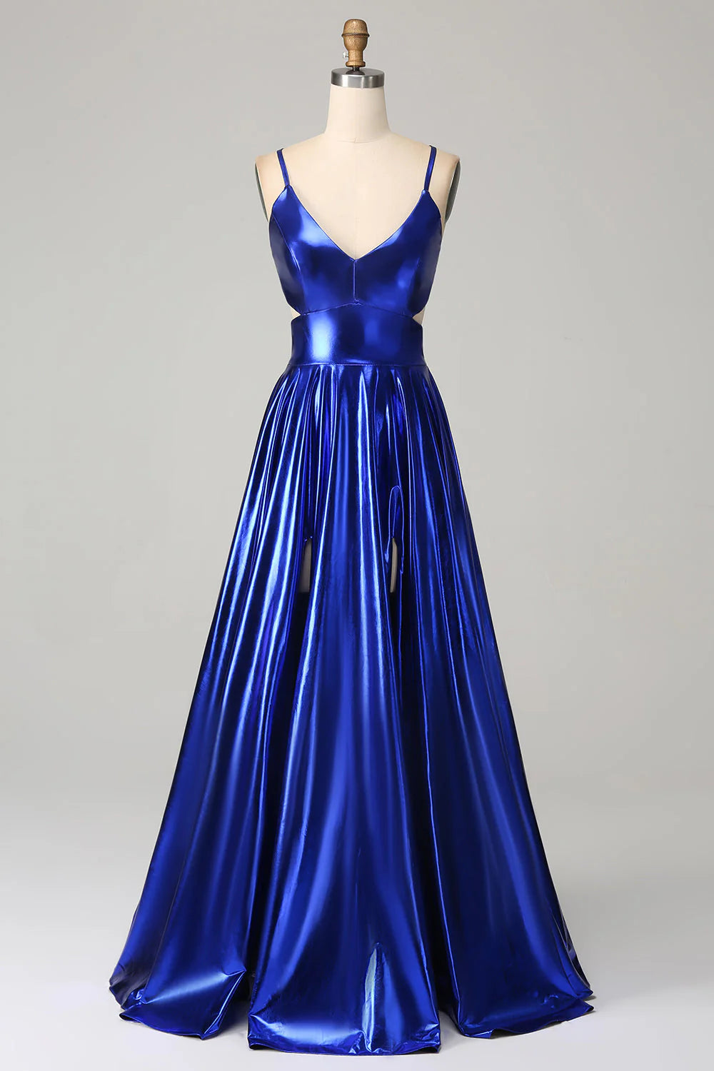 Model wearing a royal blue A-line prom dress with spaghetti straps and a high slit, front view.