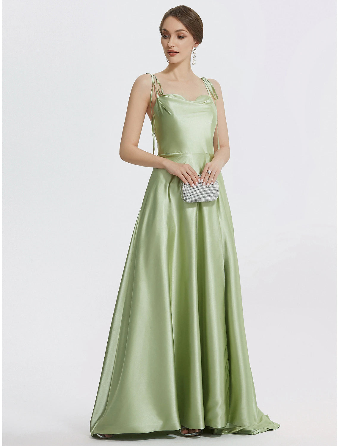 Close-up detail of the ruched slit and luxurious satin fabric on the gown.