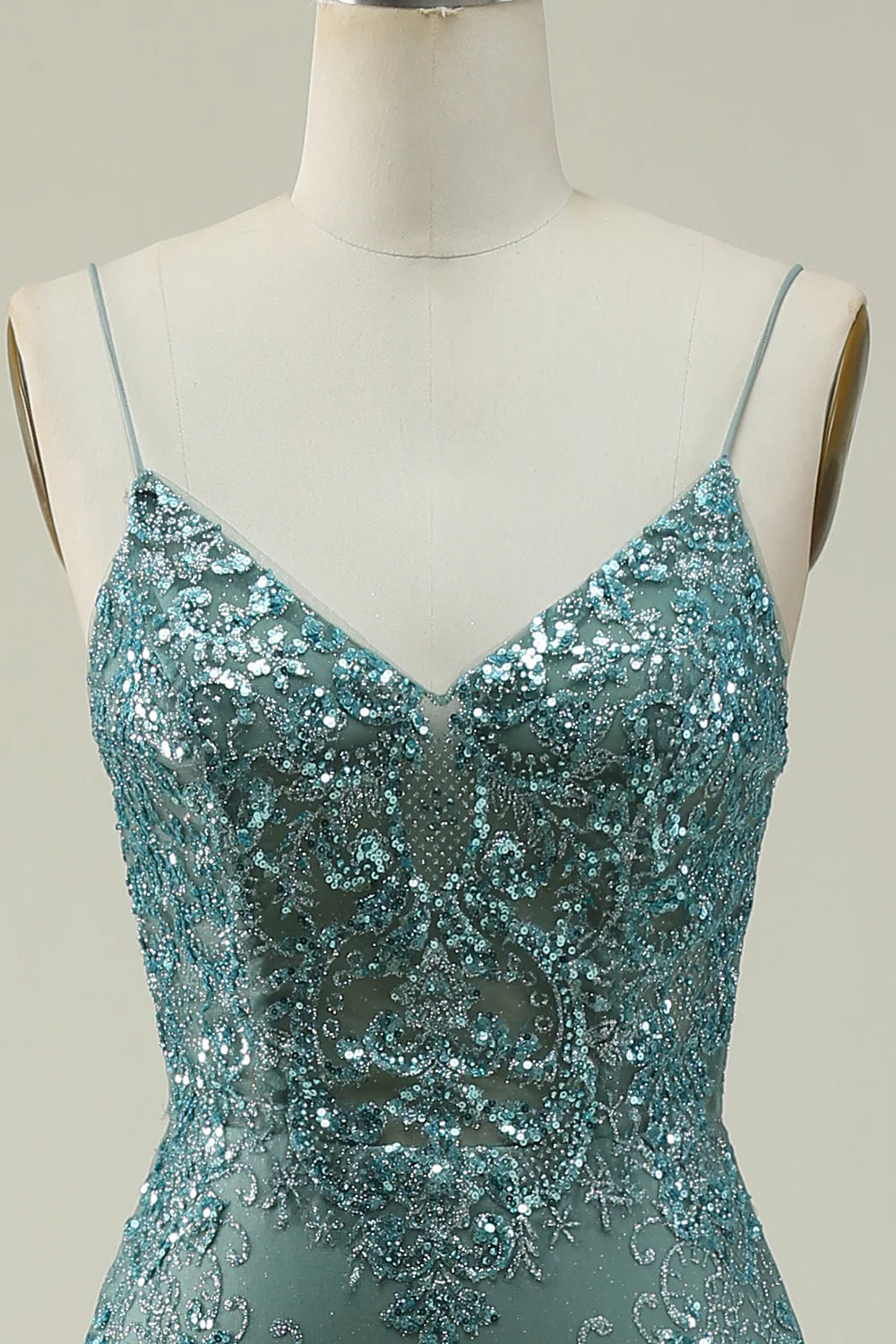 Back view of the green sequin prom dress, highlighting the delicate spaghetti straps.