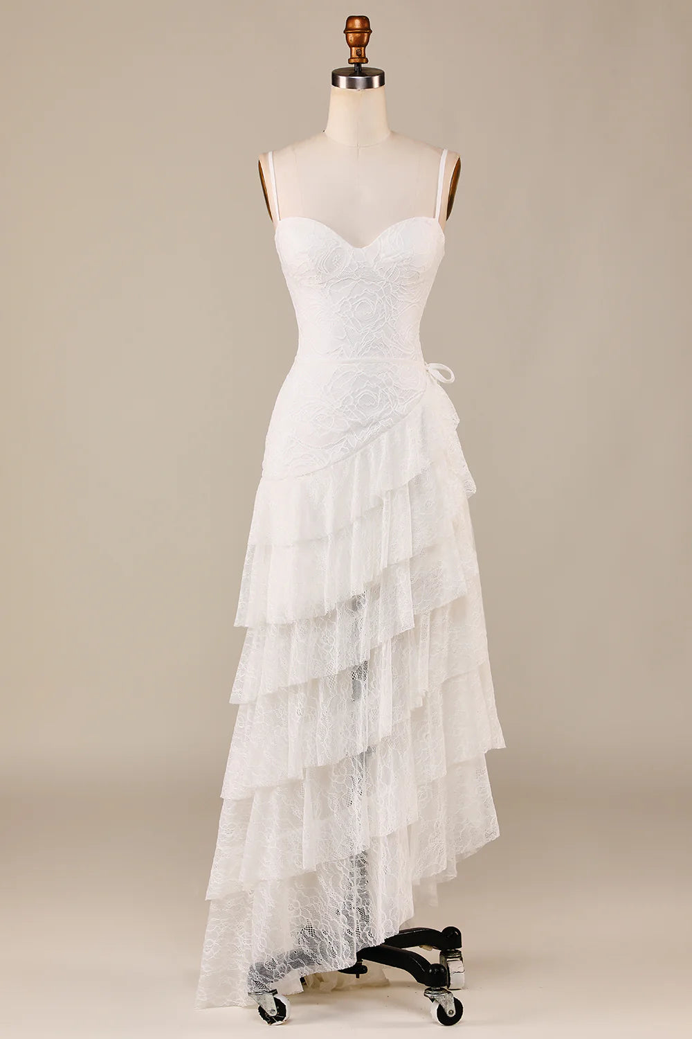 Elegant ivory tiered lace bridal dress with spaghetti straps.