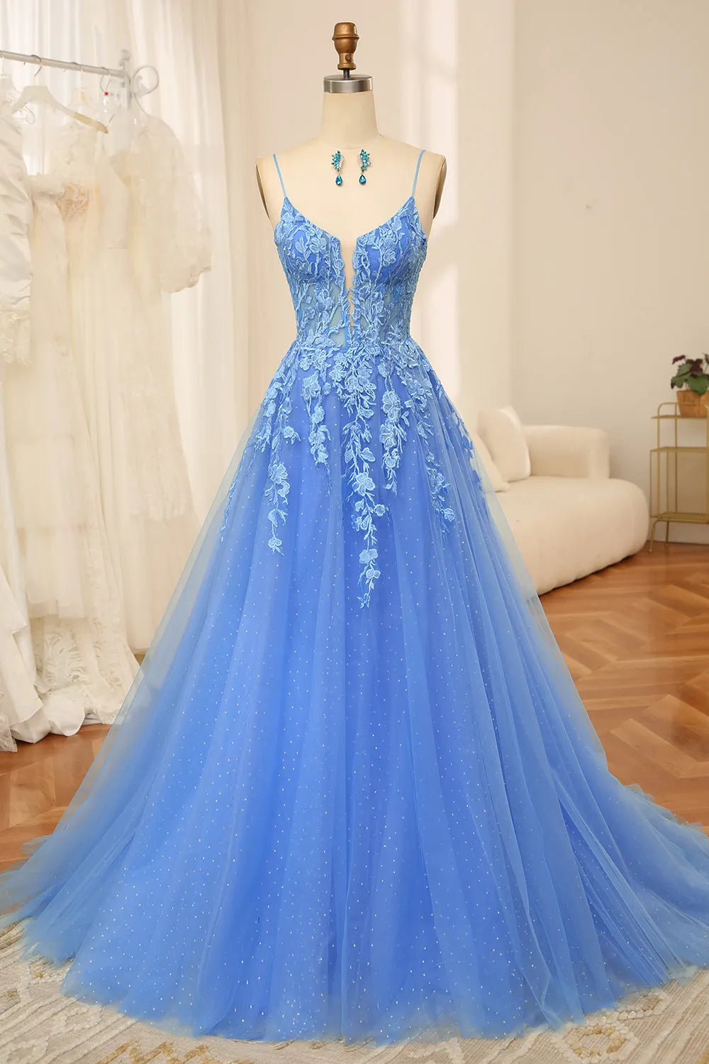 Elegant A-line blue tulle prom dress with spaghetti straps and appliques.
