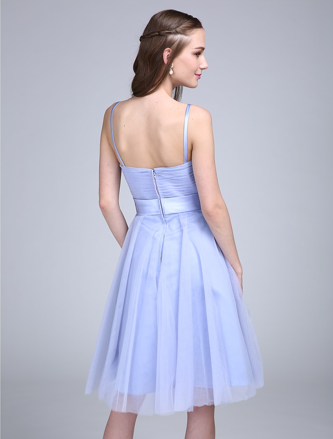 Model wearing A-line spaghetti strap bridesmaid dress.