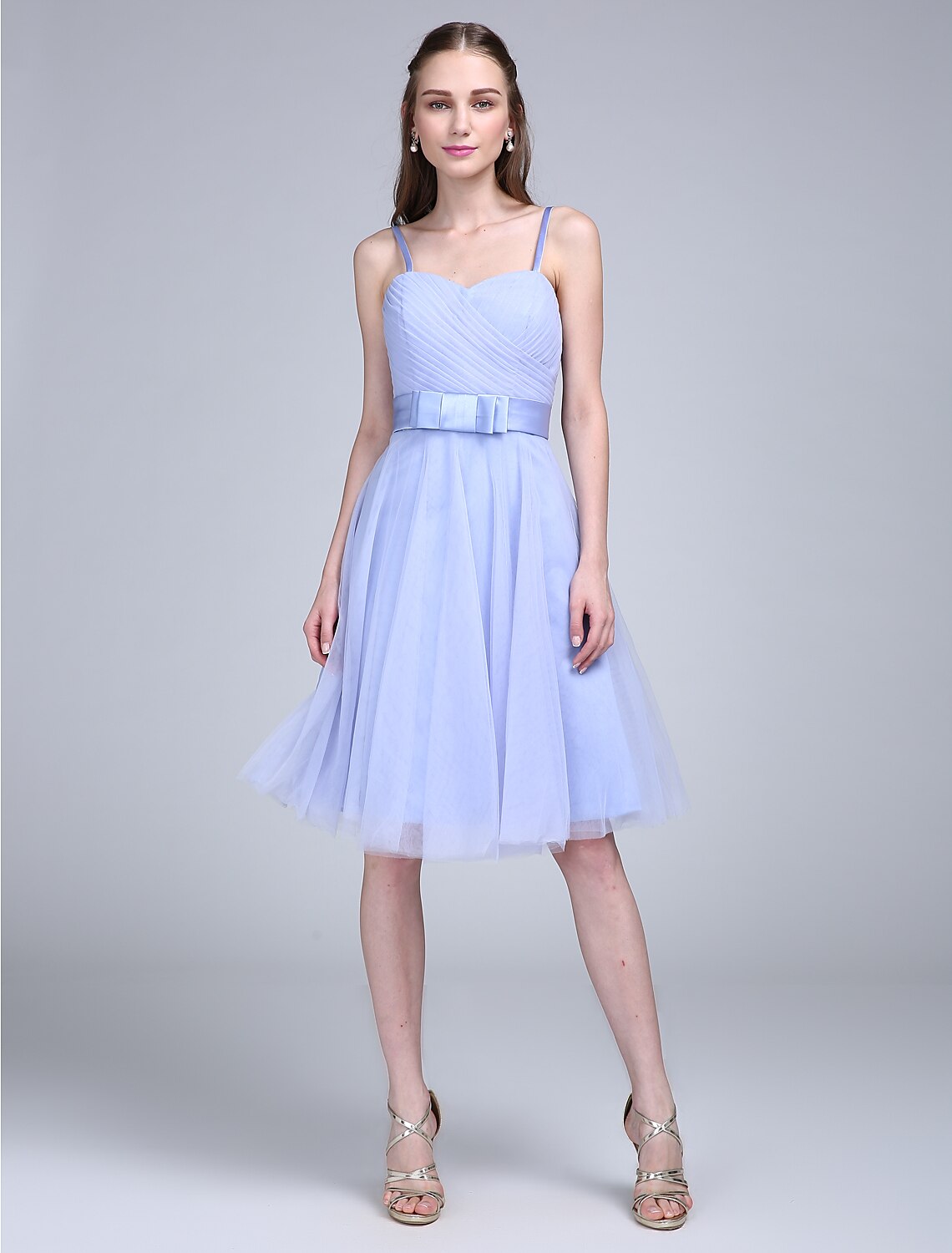 Flowing skirt of knee-length tulle bridesmaid dress.