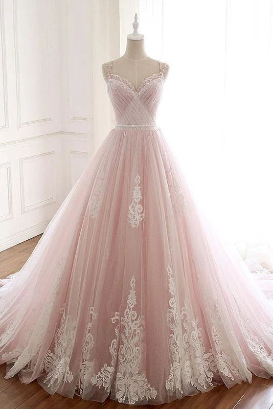 Model wearing an elegant A-line tulle prom dress with spaghetti straps and lace appliques.