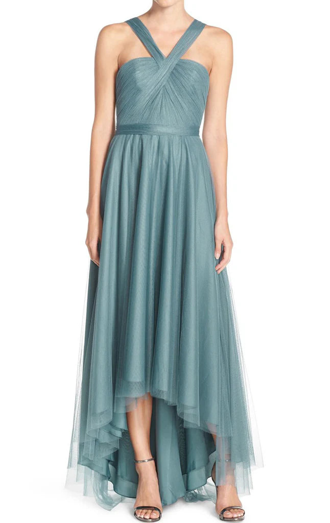 Elegant A-line tulle maxi gown with spaghetti straps on a model.